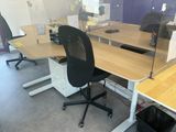 two desks with computers on them in a room