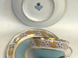 a tea cup and saucer sitting on a table