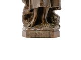 a statue of a woman holding a basket of flowers