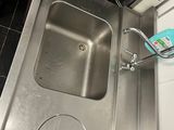a stainless steel sink in a kitchen with a dishwasher