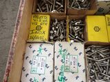 a box full of screws and nuts on the floor