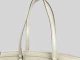 a white louis vuitton bag on a grey background