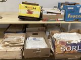 several boxes of food are stacked on a shelf in a room