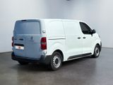 the back of a white van parked in a white room