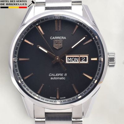a close up of a watch on a white surface