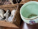 a basket of silverware and a bowl of silverware on a table