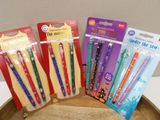 several toothbrushes are lined up in a row on a wooden tray
