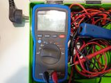 a multimeter in a green box with wires in it