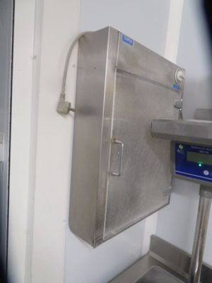 an image of a kitchen with a digital scale on the wall