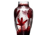 un vase orné d'une fleur rouge sur un fond blanc