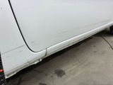 a close up of a white truck parked in a garage