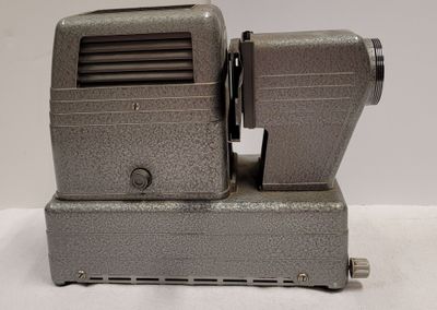 an old movie projector sitting on top of a table