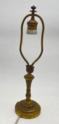 brass plated table lamp with a glass shade on the base