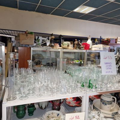 many glasses and plates on the shelves in the store