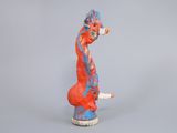 a figurine of a giraffe that is painted red and blue