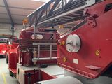 a red fire truck parked inside of a building