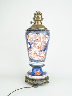 a lamp that is sitting on a table next to a white wall