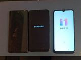 two samsung phones sitting next to each other on a table