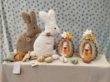 three stuffed animals sitting on a table next to other stuffed animals