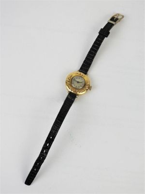a close up of a wrist watch on a white surface