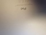 an apple logo on the back of a silver laptop