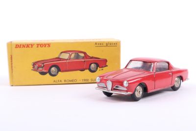 a red toy car sitting in front of a yellow box