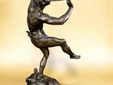 bronze statue of a man playing a trumpet on a marble base