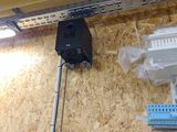 a wall mounted speaker on the side of a building