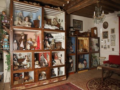 a room with a lot of dolls on display in it