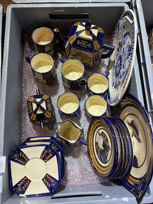 many plates and cups in a box on the table
