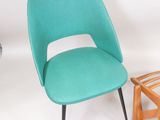 two chairs and a table in a white room