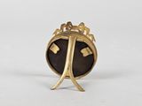 an image of a gold and black broochle broochle