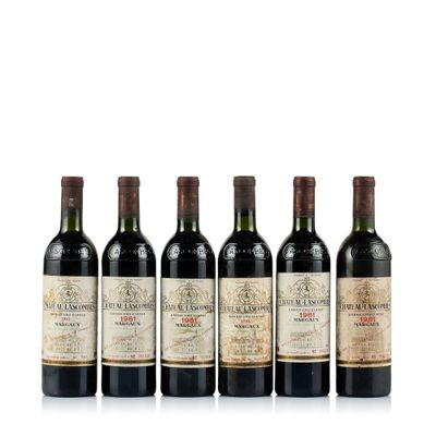 six bottles of wine are lined up on a white surface
