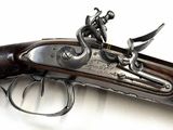 a close up of a gun on a white surface with a white background