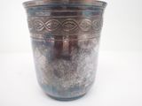 a silver vase that is sitting on a table