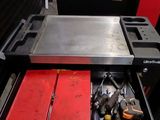 a tool drawer with tools in it in a garage