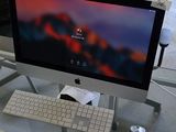 a desk with a computer monitor and keyboard on it