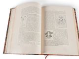 an open book with a picture of a cross on it