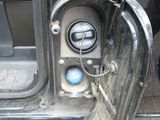 a close up of a car ' s door handle and the door handle is open