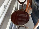 a chair and a table on a boat in the water