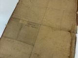 an old piece of paper sitting on top of a white table