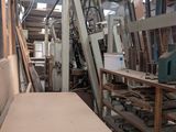 several pieces of wood are stacked on top of a table in a warehouse