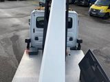 a white truck with a crane attached to it ' s back