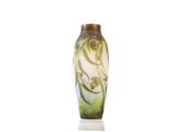 a green vase with a design on it sitting on a white surface