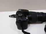 a camera that is sitting on a table next to a camera strap