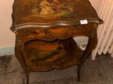 a small table with a painting on it next to a radiator