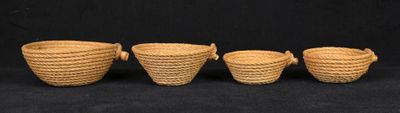 three small woven baskets are lined up against a black background