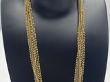 a close up of a mannequin with a necklace on it
