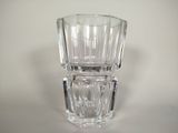 a clear glass vase sitting on top of a white table