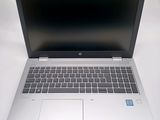 an open laptop computer sitting on top of a white table